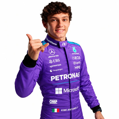 A man wearing a purple Petronas Mercedes racing suit with various sponsor logos, posing and pointing forward against a solid white background.