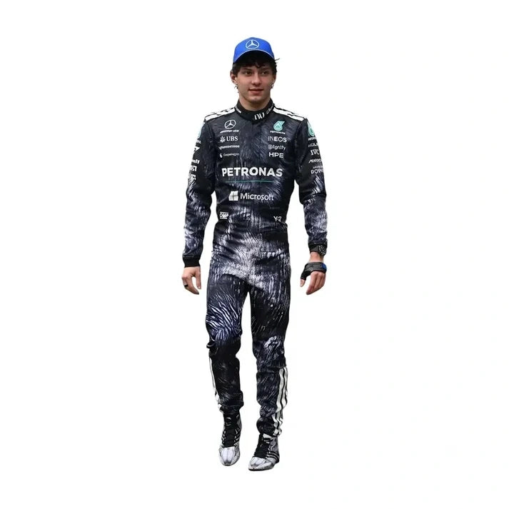 A full-body cutout of Mercedes Formula 1 driver Lewis Hamilton wearing a black and white patterned racing suit, a blue cap with a Mercedes logo, and racing shoes, on a solid white background.