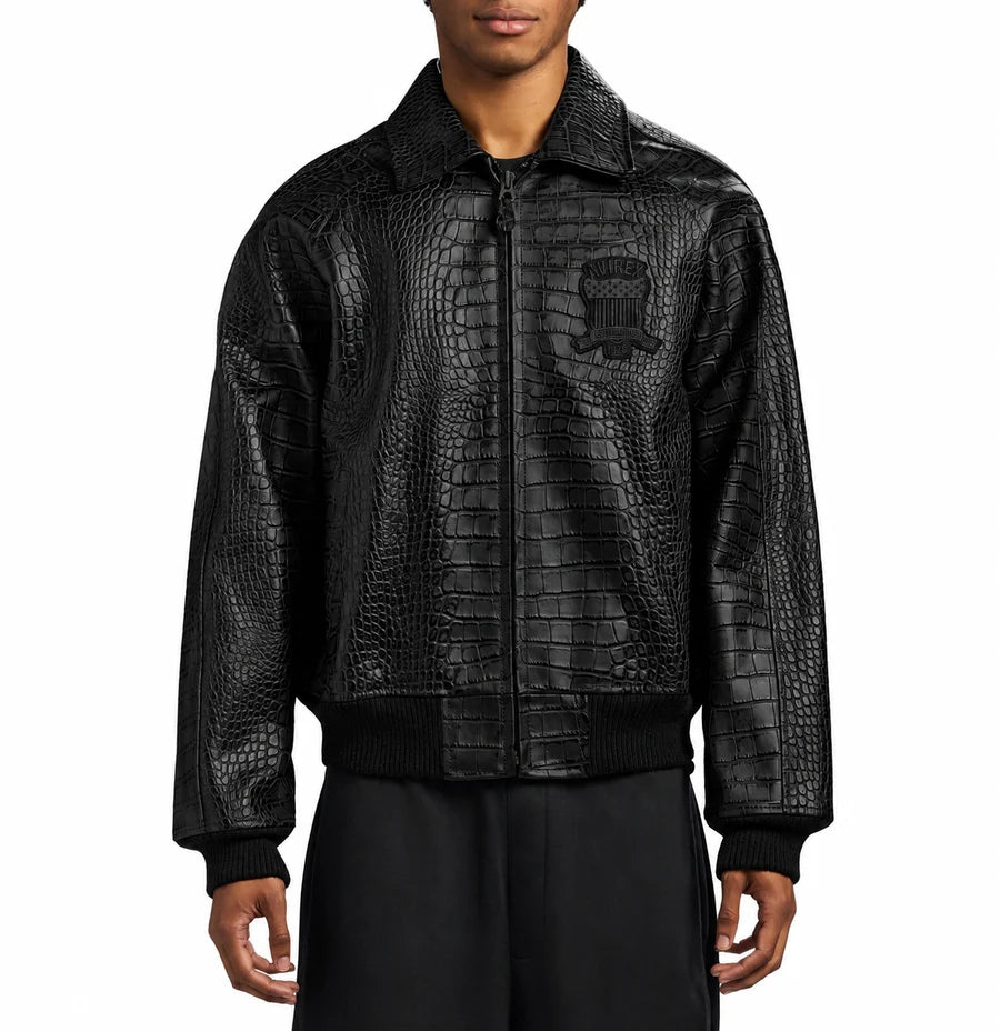 Men's black Avirex crocodile-texture leather bomber jacket with front zipper, embroidered chest logo, pointed collar and ribbed cuffs.