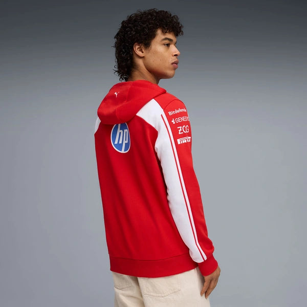 Person wearing a red hoodie with branding on a gray background
