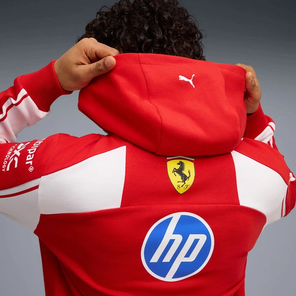 Red and white jacket with Ferrari and HP logos on a gray background