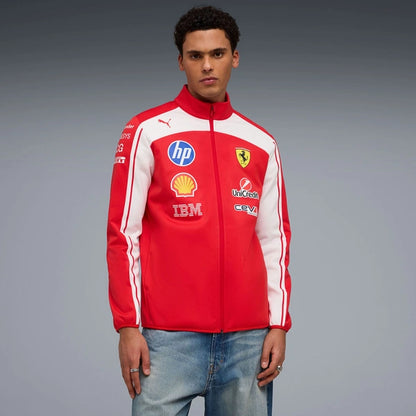 Person wearing a red and white jacket with various logos on a gray background