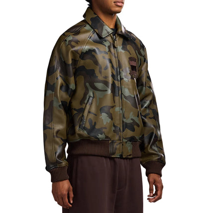 Men's AVIREX camo leather jacket angled side view showcasing military camouflage pattern, premium finish, front zipper and classic bomber silhouette