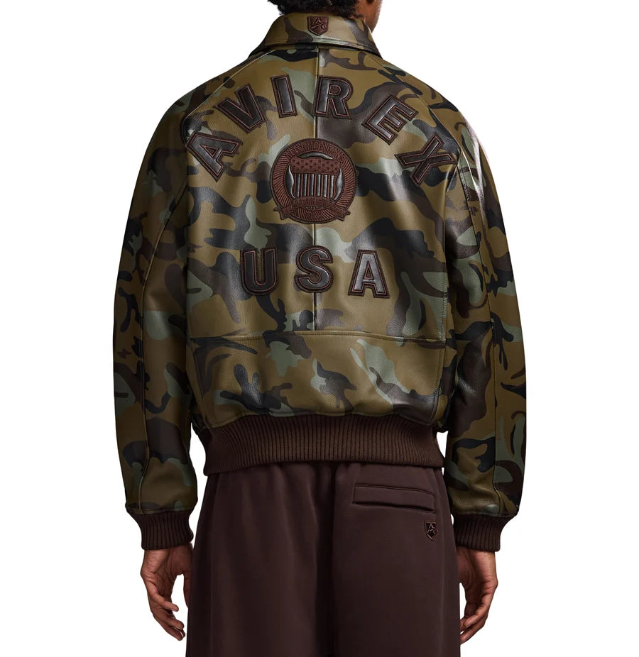 AVIREX men's camouflage leather jacket back view on model featuring large AVIREX USA lettering, embroidered emblem and ribbed hem