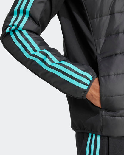 Close-up of black Mercedes F1 puffer jacket showing turquoise three-stripe sleeve detailing