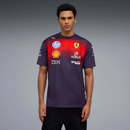 A man modeling a Scuderia Ferrari Scuderietek Puma Racing Team short-sleeve t-shirt in dark purple with a red gradient on the chest, featuring various sponsor logos including HP, Shell, and Lenovo.