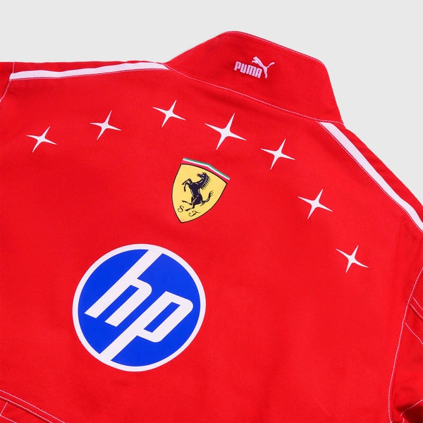 Close-up of a red Puma Ferrari track jacket showing the collar, Ferrari shield logo, star motifs, and a blue HP logo on the chest.