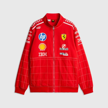 A red Scuderia Ferrari zip-up jacket featuring multiple sponsor logos including HP, Shell, and IBM, displayed against a light gray background.