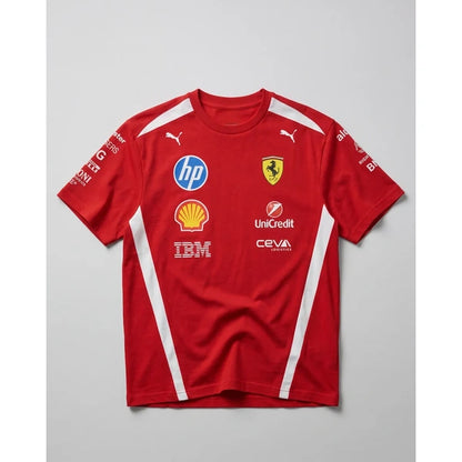 A red short-sleeve Scuderia Ferrari T-shirt with white side stripes and multiple sponsor logos, displayed flat against a light gray background.