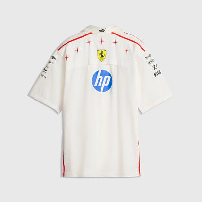 A white short-sleeve Scuderia Ferrari T-shirt shown from the back, featuring red star accents, the yellow Ferrari prancing horse crest, a blue HP logo, and black sponsor logos on the shoulders, against a light gray background.